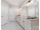 Large bathroom with dual sinks, granite countertops, and white cabinets at 4005 Capullo Ct, Matthews, NC 28104