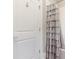 White bathroom door and gray ruffle shower curtain in modern bathroom at 4005 Capullo Ct, Matthews, NC 28104
