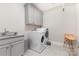 Laundry room with granite sink, LG washer and dryer, cabinets, and tile flooring at 4005 Capullo Ct, Matthews, NC 28104