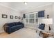 Comfortable living room with sofa, window, and neutral carpet at 4005 Capullo Ct, Matthews, NC 28104
