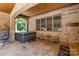 Outdoor hot tub with covered patio, brick columns and hardwood ceiling at 4005 Capullo Ct, Matthews, NC 28104