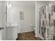 Bathroom featuring a white vanity, framed art, and neutral patterned shower curtain at 4013 Southern Pine Dr, Mount Holly, NC 28120
