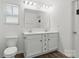 Bathroom featuring double sinks, a large mirror, and white cabinetry at 4013 Southern Pine Dr, Mount Holly, NC 28120