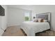 Bedroom features soft carpet, a padded headboard, and a bright window at 4013 Southern Pine Dr, Mount Holly, NC 28120
