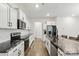 Modern kitchen featuring white cabinets, stainless steel appliances, and granite countertops at 4013 Southern Pine Dr, Mount Holly, NC 28120