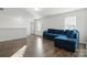 Bright living room with hardwood floors, natural light, and a comfortable couch at 4013 Southern Pine Dr, Mount Holly, NC 28120
