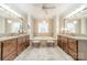 Bright bathroom with dual vanities, a soaking tub and elegant fixtures at 4075 Crepe Ridge Dr, Denver, NC 28037