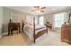 Bright bedroom with a wood frame bed, desk, and natural light at 4075 Crepe Ridge Dr, Denver, NC 28037