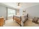 Comfortable bedroom with a wood frame bed, ceiling fan, and natural light at 4075 Crepe Ridge Dr, Denver, NC 28037