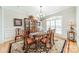 Elegant dining room featuring a chandelier, decorative rug, and a large window with plantation shutters at 4075 Crepe Ridge Dr, Denver, NC 28037