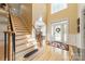 Bright foyer with hardwood floors, staircase, and decorative front door with a leaded glass sidelight at 4075 Crepe Ridge Dr, Denver, NC 28037