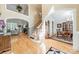 Grand foyer with hardwood floors, staircase, arched entryways, and views into the living and dining areas at 4075 Crepe Ridge Dr, Denver, NC 28037
