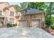 Attached two-car garage with neutral doors, exterior brickwork, and an American flag at 4075 Crepe Ridge Dr, Denver, NC 28037