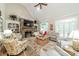 Cozy living room with a stone fireplace, vaulted ceilings, built-in shelves, and comfortable seating at 4075 Crepe Ridge Dr, Denver, NC 28037
