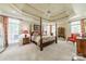 Spacious primary bedroom featuring a four-poster bed, trey ceiling and large windows at 4075 Crepe Ridge Dr, Denver, NC 28037