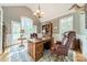 Bright office space with a large desk, leather chair, bookcase, and plenty of natural light at 4075 Crepe Ridge Dr, Denver, NC 28037