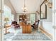 Home office with wooden desk, leather chairs, a large window, and a decorative chandelier at 4075 Crepe Ridge Dr, Denver, NC 28037