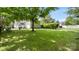 Spacious backyard with a green lawn, mature tree providing shade, white fence in background at 4115 Birkshire Hts, Fort Mill, SC 29708