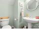 Charming half bathroom features a pedestal sink and decorative mirror at 4115 Birkshire Hts, Fort Mill, SC 29708