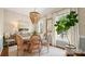 Inviting dining room with chandelier, light-colored walls, and large windows with sheer curtains at 4115 Birkshire Hts, Fort Mill, SC 29708