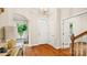 Bright foyer featuring hardwood floors, white trim, arched doorway, and a stylish console table at 4115 Birkshire Hts, Fort Mill, SC 29708