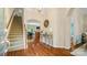 Elegant foyer with hardwood floors, staircase, chandelier, and decorative console table at 4115 Birkshire Hts, Fort Mill, SC 29708