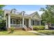 Quaint two-story house with dormer windows and an inviting front porch with hanging flower baskets at 4115 Birkshire Hts, Fort Mill, SC 29708