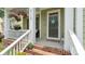 Charming front porch with brick stairs, potted flowers, and a 'Come in Cozy Up' welcome mat at 4115 Birkshire Hts, Fort Mill, SC 29708