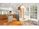 Well-lit kitchen features hardwood floors, stainless steel appliances, island, and breakfast nook at 4115 Birkshire Hts, Fort Mill, SC 29708
