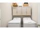 Efficient laundry room featuring matching washer and dryer with overhead cabinets at 4115 Birkshire Hts, Fort Mill, SC 29708