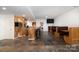 Basement with wood bar and booth seating; ideal for entertaining with a kitchen area and tv at 4201 Amber Leigh Way Dr, Charlotte, NC 28269