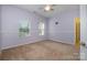 Bedroom with neutral carpet and walls, ceiling fan, and two windows for ample natural light at 4201 Amber Leigh Way Dr, Charlotte, NC 28269