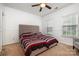 This bedroom features a double bed, a ceiling fan, carpeting, and two windows for natural light at 4201 Amber Leigh Way Dr, Charlotte, NC 28269