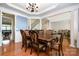 Elegant dining room featuring a large wooden table with seating for six, bathed in natural light at 4201 Amber Leigh Way Dr, Charlotte, NC 28269