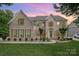 Charming two-story brick home with lush landscaping and a well-manicured front lawn at 4201 Amber Leigh Way Dr, Charlotte, NC 28269