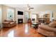 Inviting living room featuring a fireplace, hardwood floors, and seamless access to the kitchen at 4201 Amber Leigh Way Dr, Charlotte, NC 28269