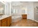 Bright main bathroom with soaking tub, dual vanities, and separate shower at 4201 Amber Leigh Way Dr, Charlotte, NC 28269