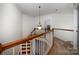 Elegant staircase with wood railings and carpeted steps at 4201 Amber Leigh Way Dr, Charlotte, NC 28269
