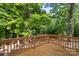 Wooden deck with lush green trees in the background, creating a private and serene outdoor space at 4410 Burgin St, Kannapolis, NC 28081
