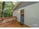 A cozy back porch with a wooden deck and a gray door, offering a serene outdoor retreat at 4410 Burgin St, Kannapolis, NC 28081