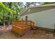Back porch with wooden deck and steps, complemented by a home's light siding and leafy green trees at 4410 Burgin St, Kannapolis, NC 28081