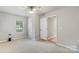 Bright bedroom featuring neutral walls, a ceiling fan, carpeted floor, and natural light from a window at 4410 Burgin St, Kannapolis, NC 28081