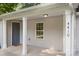 Close-up of a cozy front porch with a gray door, white columns, and the house number displayed prominently at 4410 Burgin St, Kannapolis, NC 28081