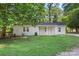 Attractive home featuring a brick facade, a covered porch, and a well-manicured lawn, providing a welcoming curb appeal at 4410 Burgin St, Kannapolis, NC 28081