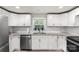 Well-lit kitchen featuring stainless steel appliances, granite countertops, and ample white cabinetry at 4410 Burgin St, Kannapolis, NC 28081