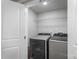 Laundry room features a modern washer and dryer with a wire shelf for storage at 4410 Burgin St, Kannapolis, NC 28081