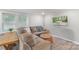 Inviting living room with a large sectional sofa, a cozy ottoman, and ample natural light from the windows at 4410 Burgin St, Kannapolis, NC 28081