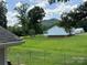 Lush backyard view of home, trees, and hills at 4421 Linwood Rd, Gastonia, NC 28052