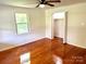 This bedroom features hardwood floors, bright lighting and a connected closet space for organized and serene living at 4421 Linwood Rd, Gastonia, NC 28052