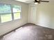 Cozy bedroom with plush carpet, a ceiling fan, and bright windows for a relaxing and comfortable space at 4421 Linwood Rd, Gastonia, NC 28052